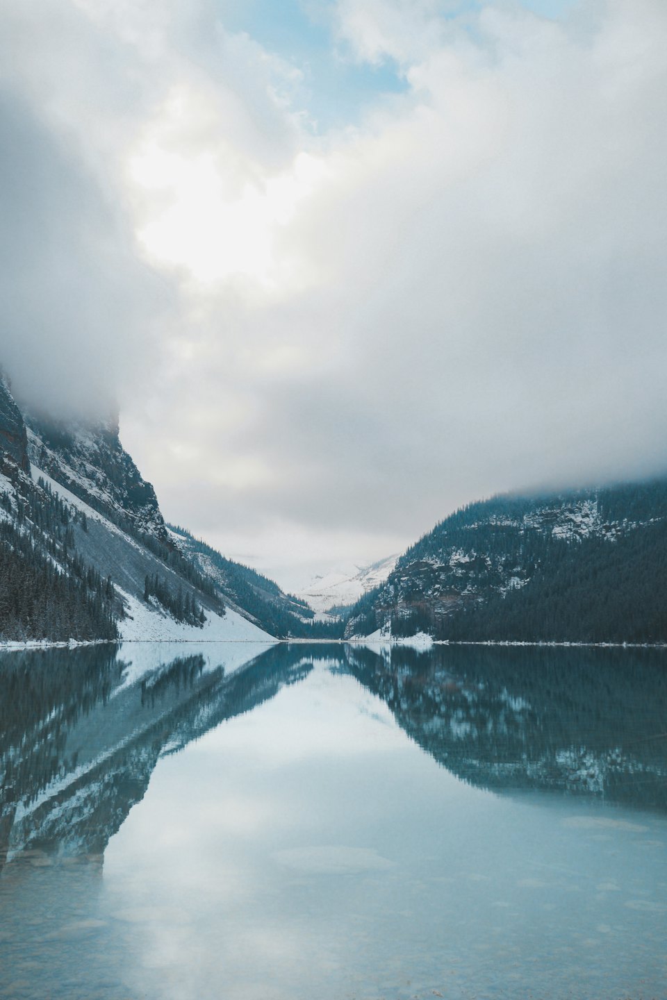 Snowy mountain peaks reflected in a calm lake.
