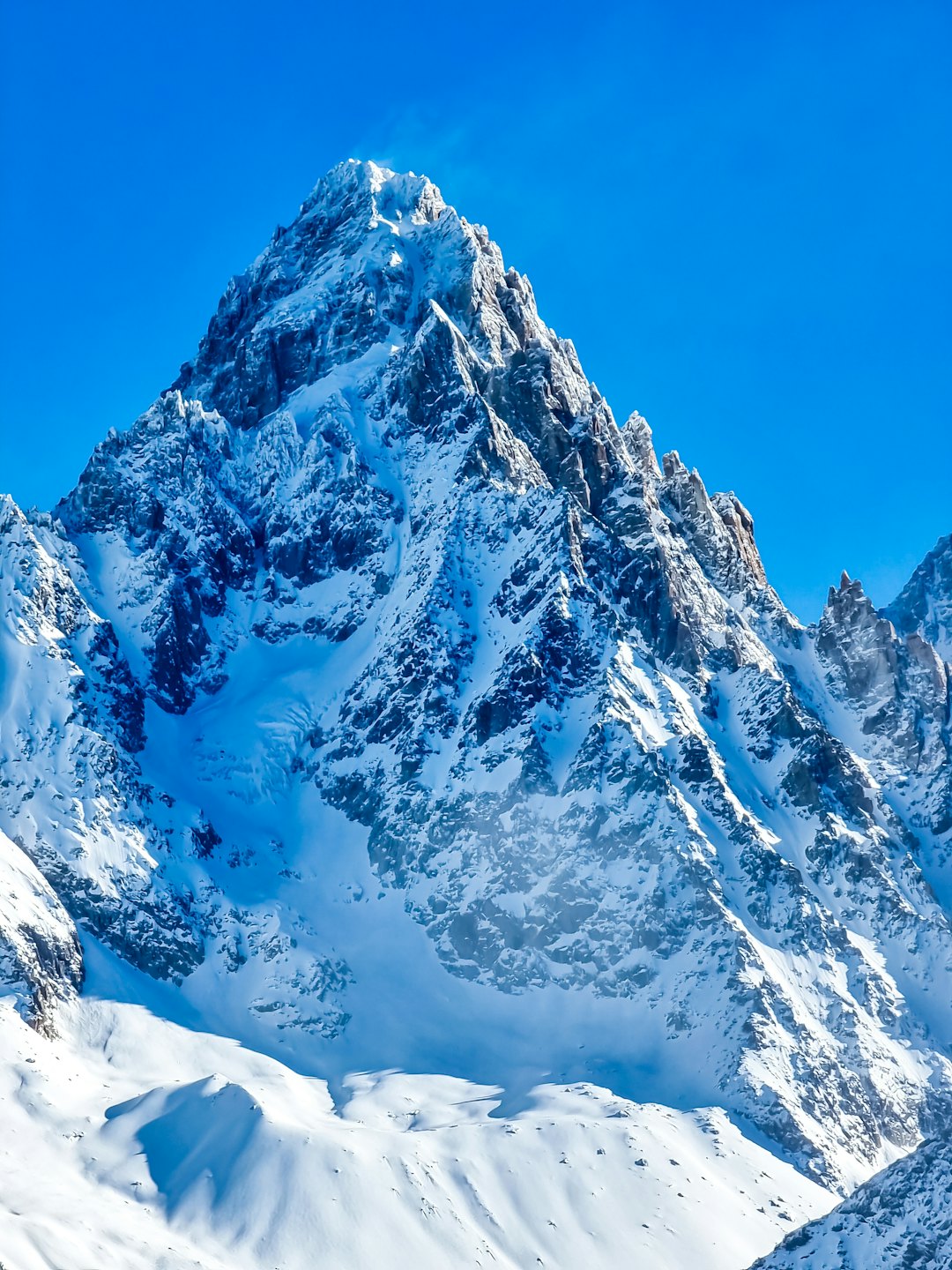 Snow-capped mountain peak under a clear blue sky.